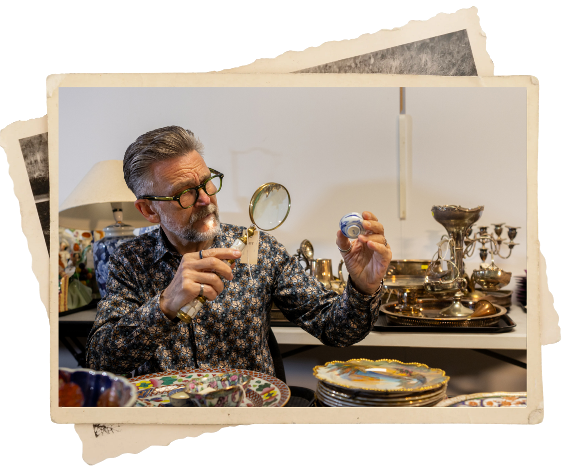 A professional appraiser examines vintage jewelry to buy and sell antiques.