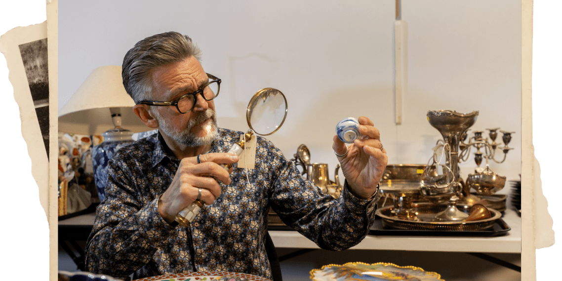 A professional appraiser examines vintage jewelry to buy and sell antiques.